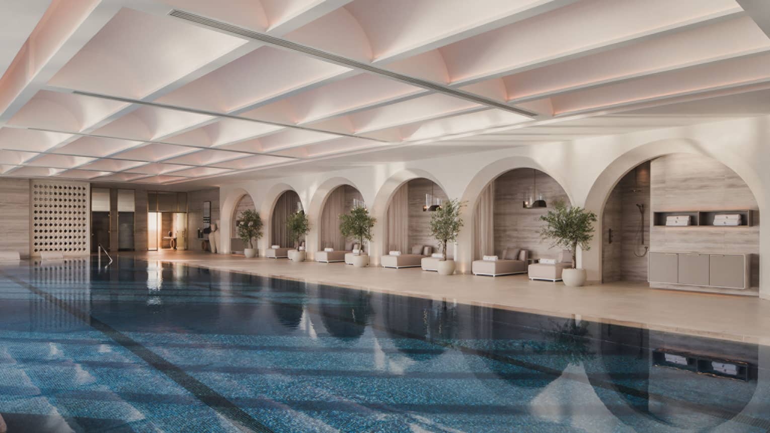 Large indoor swimming pool with pool lounge chairs