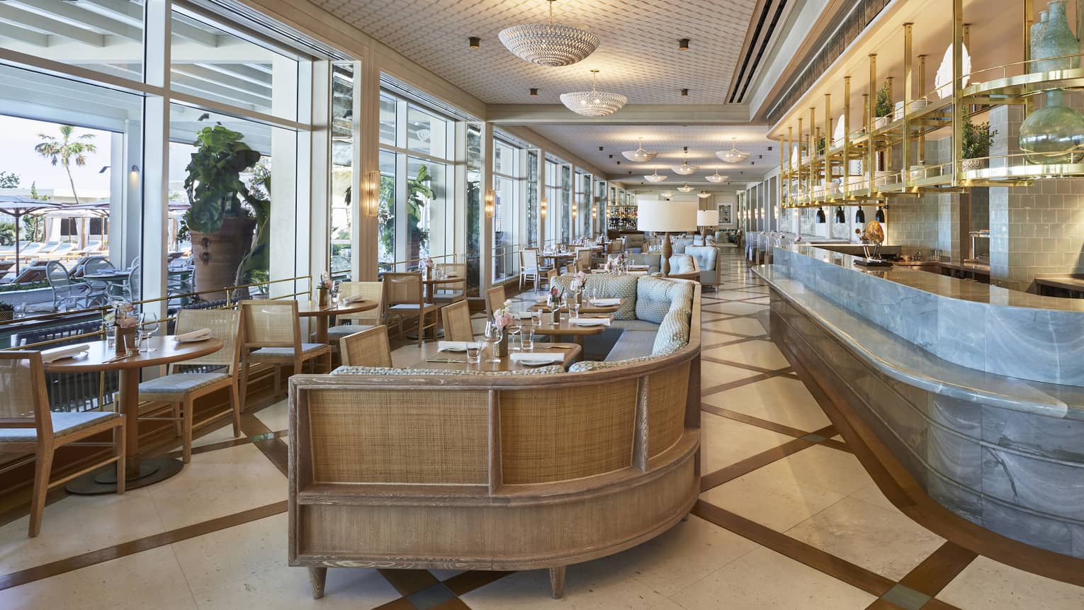 Florie’s restaurant wall of windows, dining room tables, banquettes and marble bar