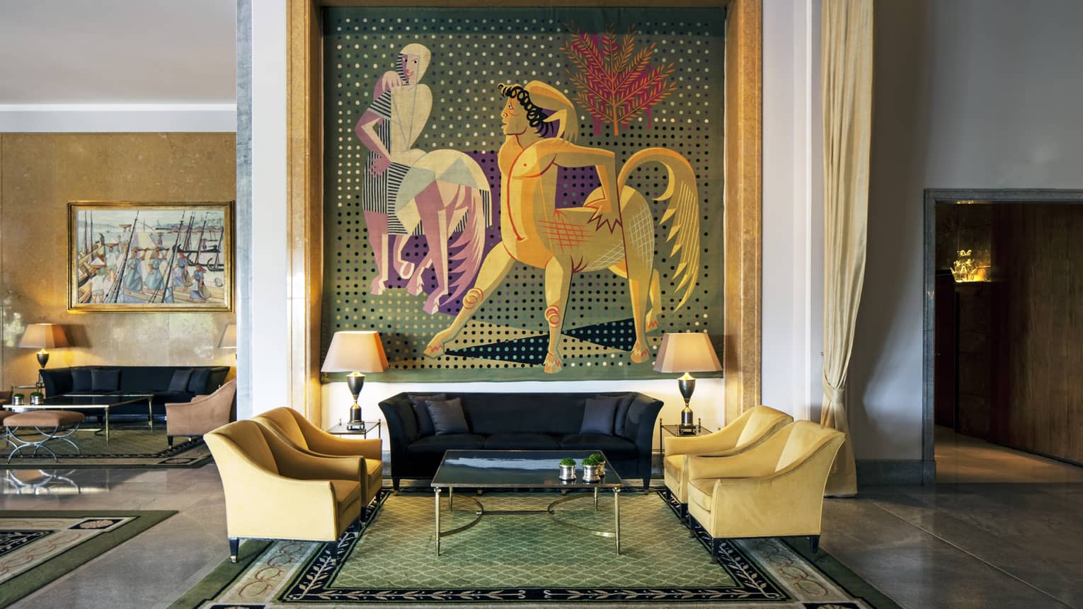 Almada Negreiros Lounge yellow armchairs below large handmade tapestry depicting centaurs