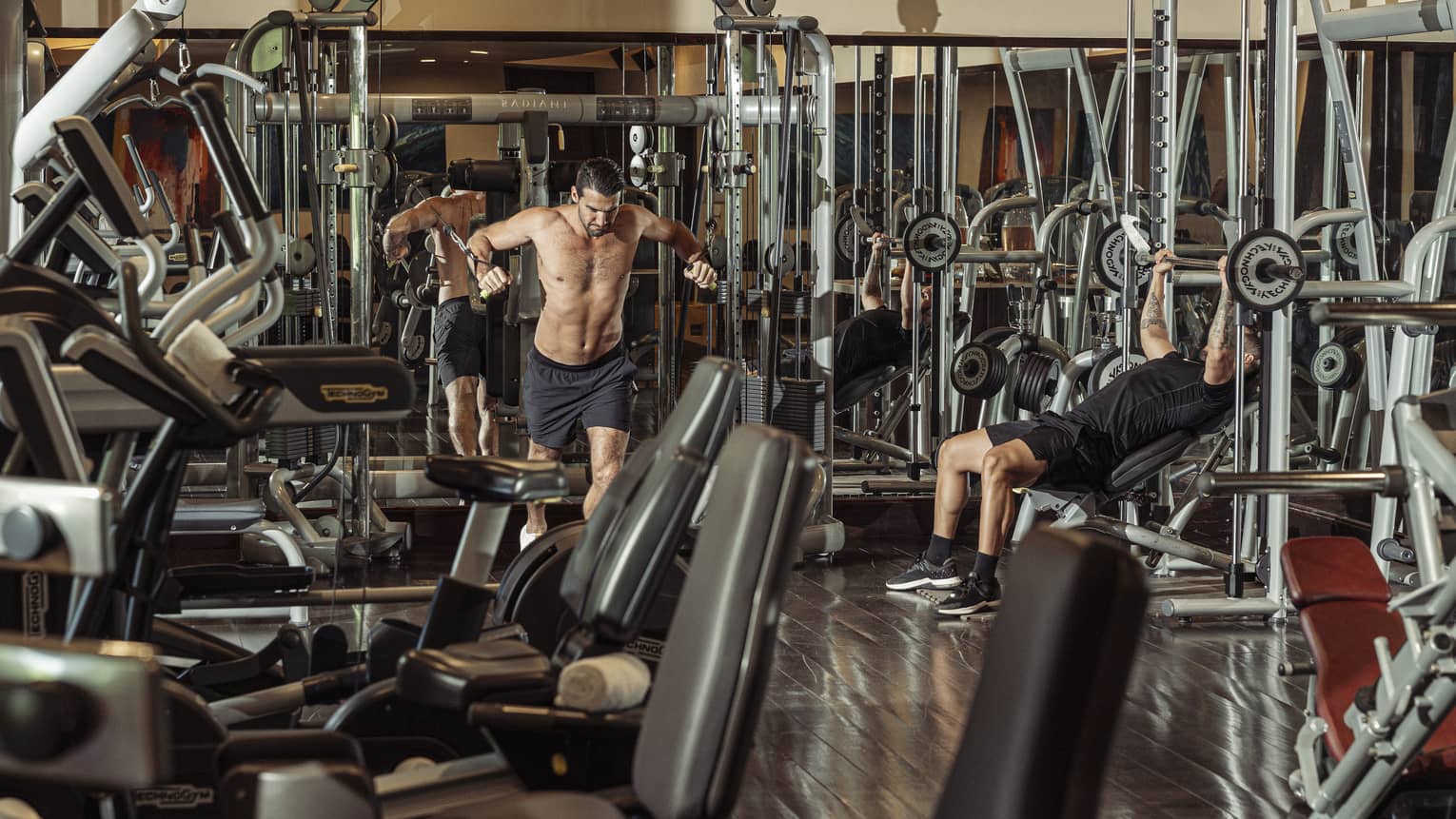 Two people working out on weight equipment in Fitness Centre