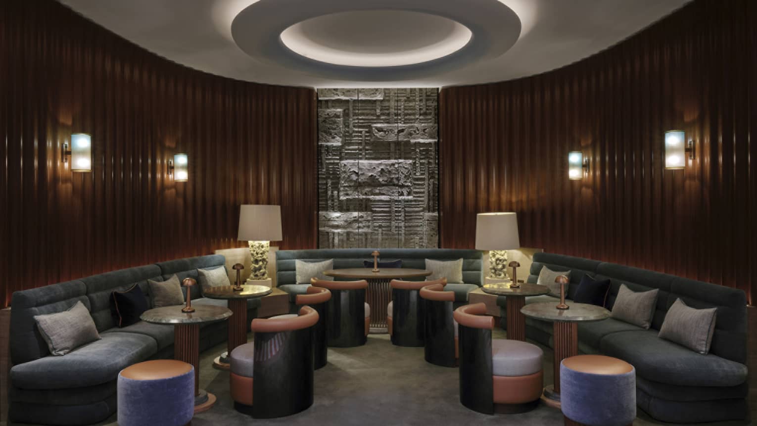 Lounge with large curved sofa, molding to curved wooden walls