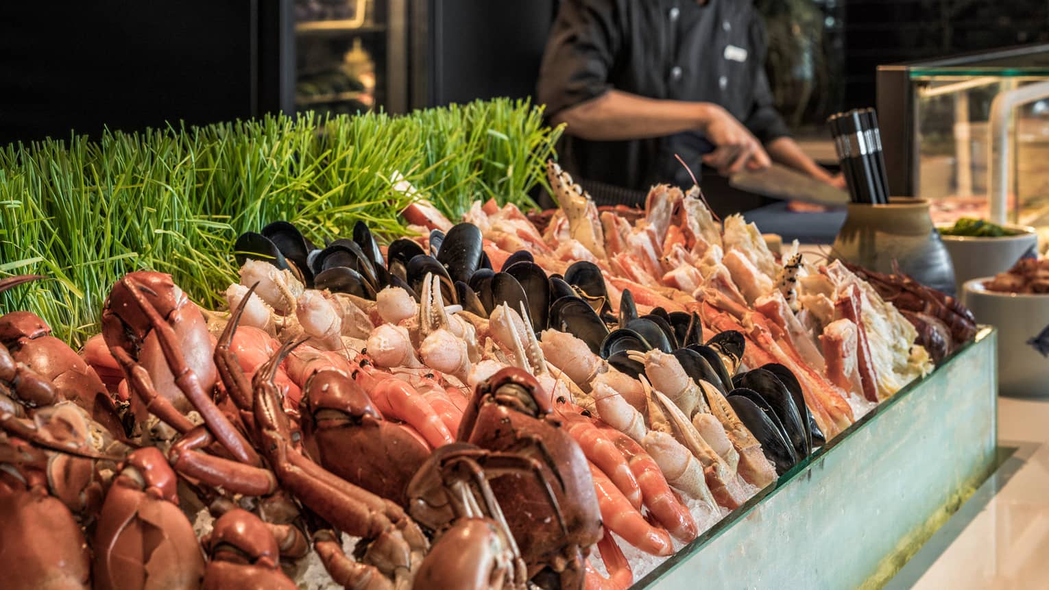 Curate seafood station with chef laying out food