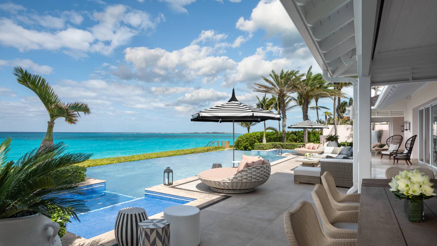 Sunny Beachfront Villa Residence Terrace with modern patio lounge furniture, swimming pool