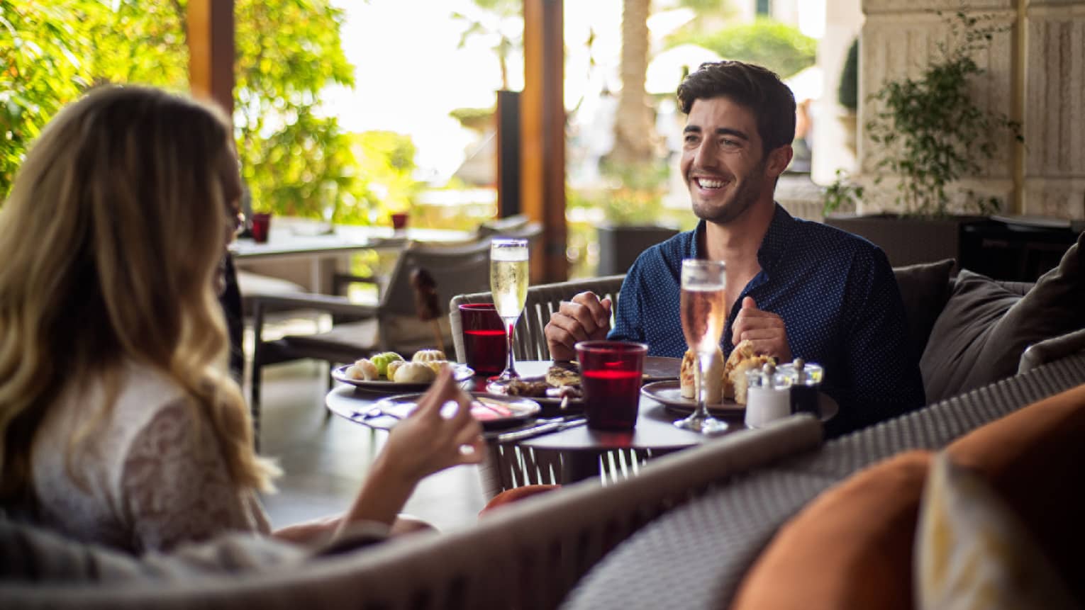 Smiling couple dining at restaurant table