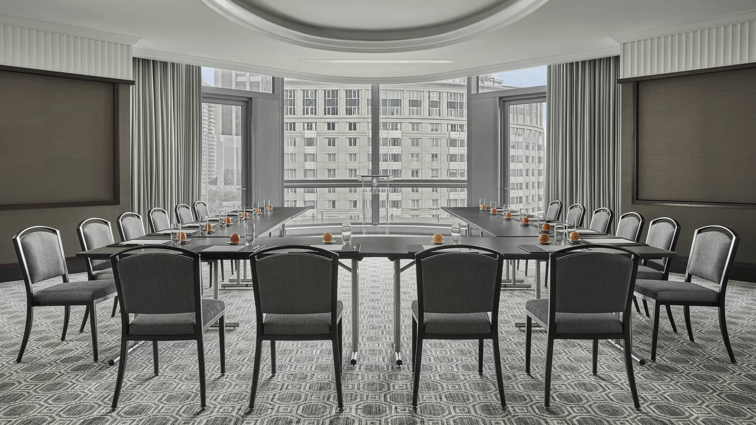 Empty Dartmouth Room, but ready for an event, with the wide rectangular table set with paper and pens