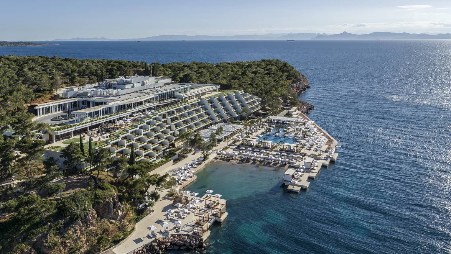 Aerial view over Athens Four Seasons Hotel and Resort buildings and water