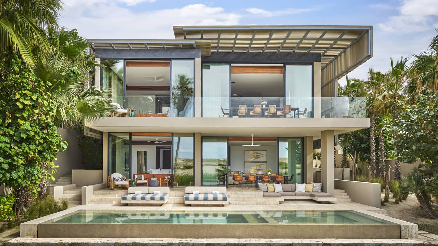 Exterior of the contemporary two-storey luxury Five-Bedroom Oasis Villa with tall windows and private pool