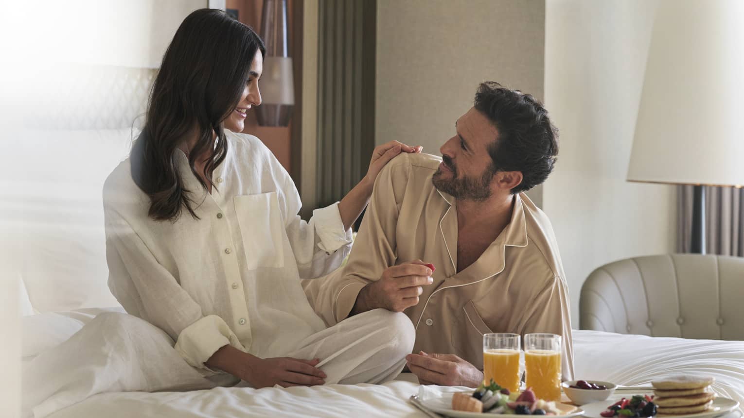 Pajama-clad couple enjoys in-room dining in their guest room