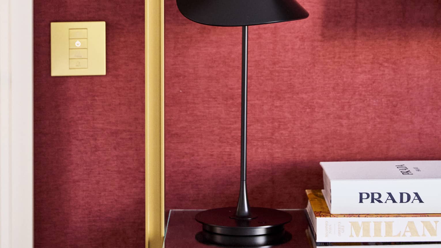 Detail of a stylish hotel room, featuring a Prada and Milan coffee table book