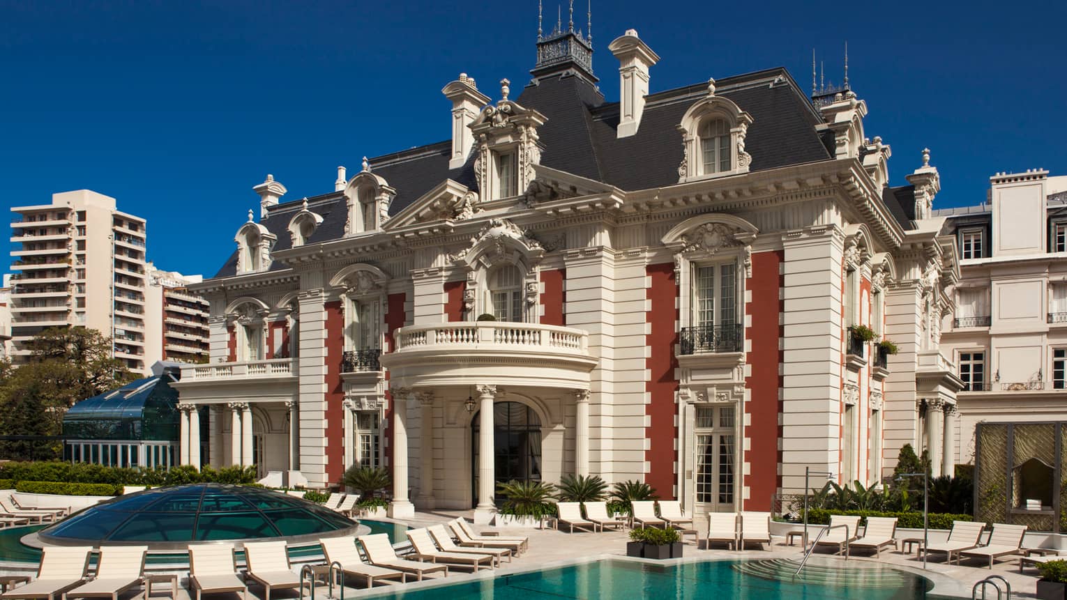 Exterior view of Four Seasons Buenos Aires hotel in historic white mansion with swimming pool