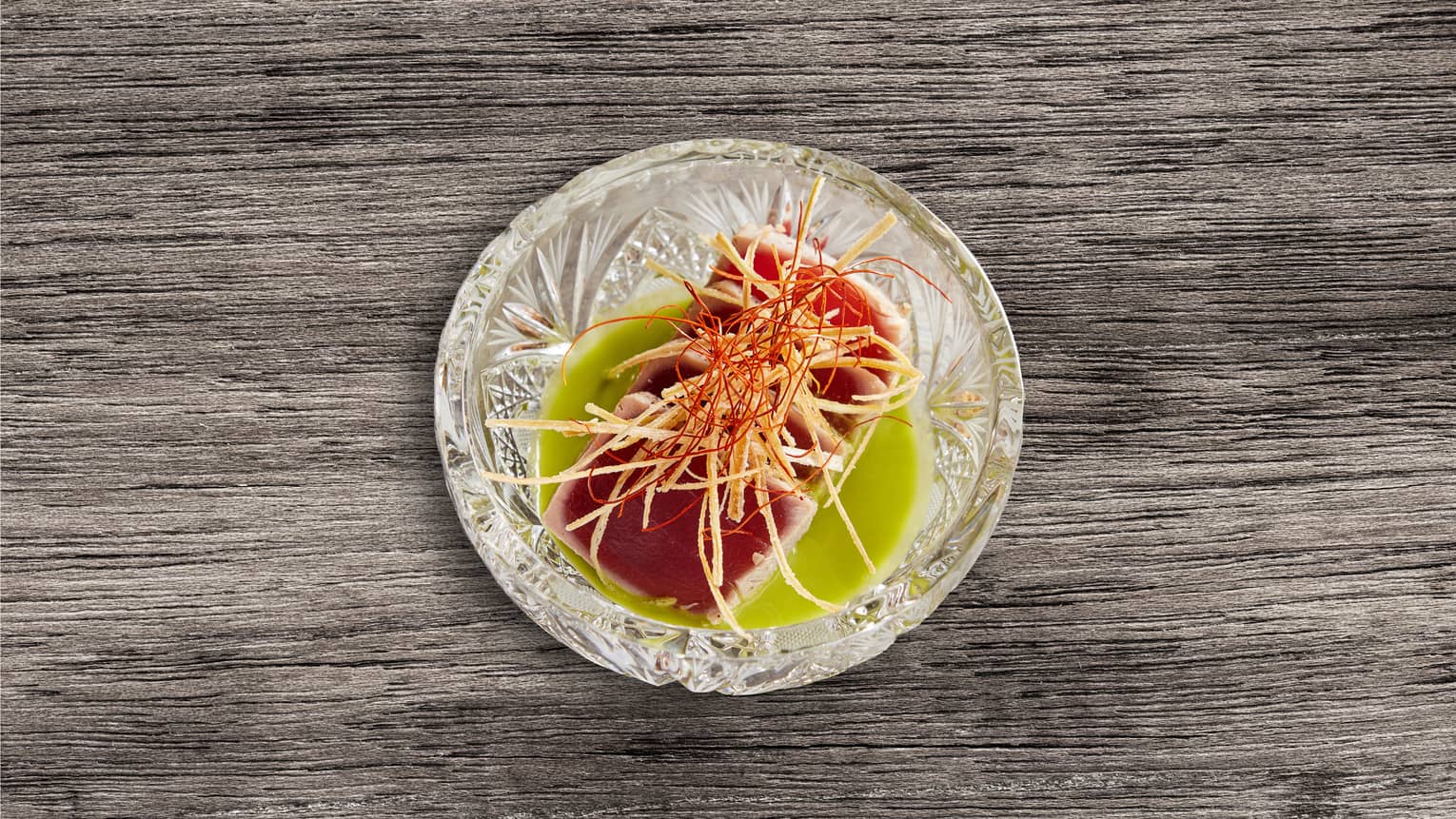 Seared Tuna with a green sauce and crispy leeks.