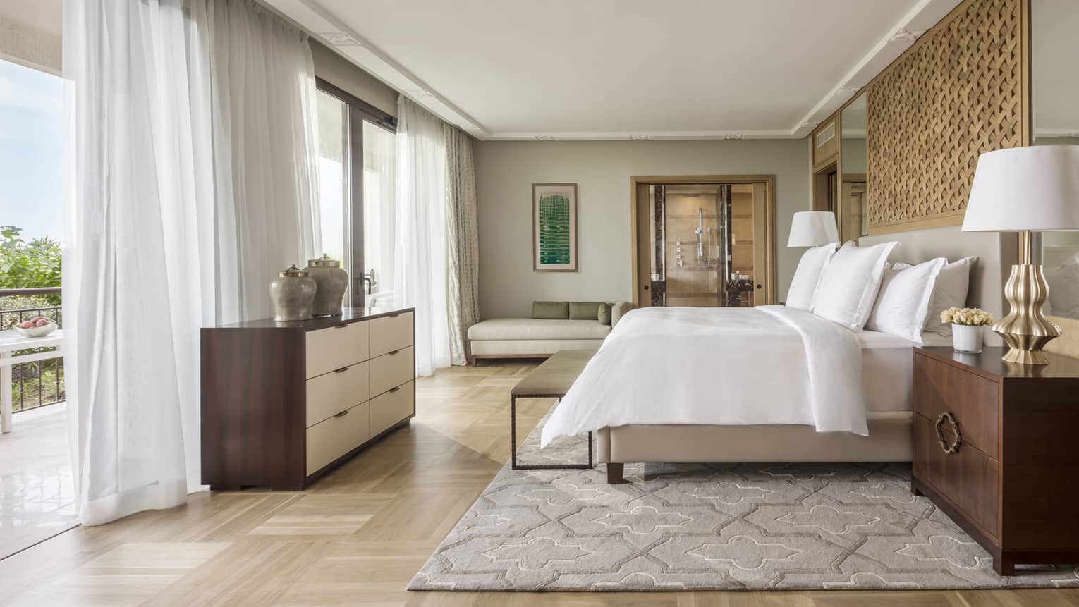 Light-filled Mediterranean Suite, bed with white bedding faces floor to ceiling windows with sheer curtains