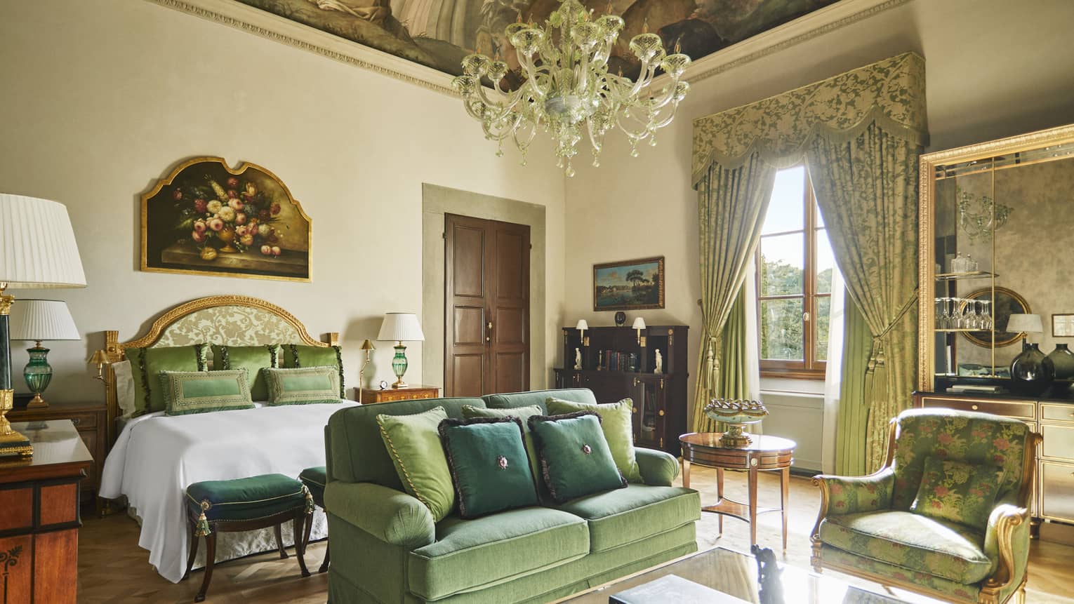 Renaissance Suite king bedroom with frescoed ceiling and chandelier, at Four Seasons Hotel Florence