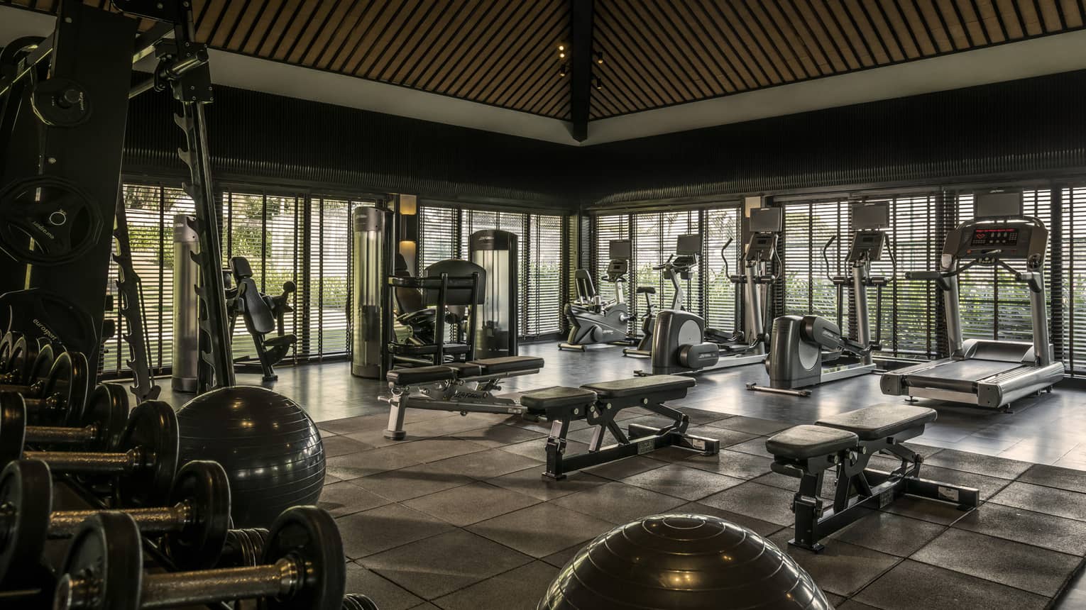 A spacious fitness centre with various exercise equipment.