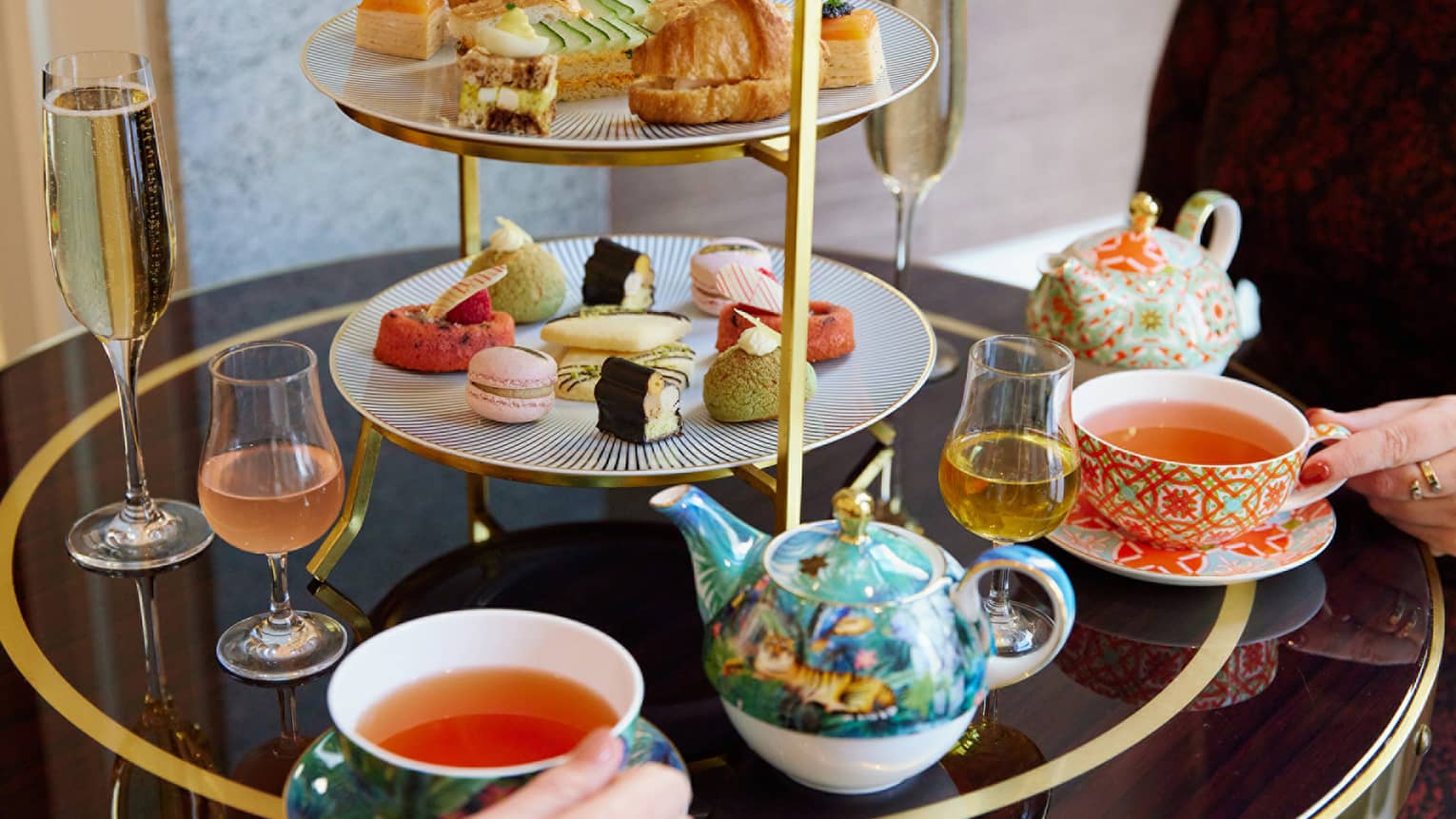 A tea set with pastries and small foods.