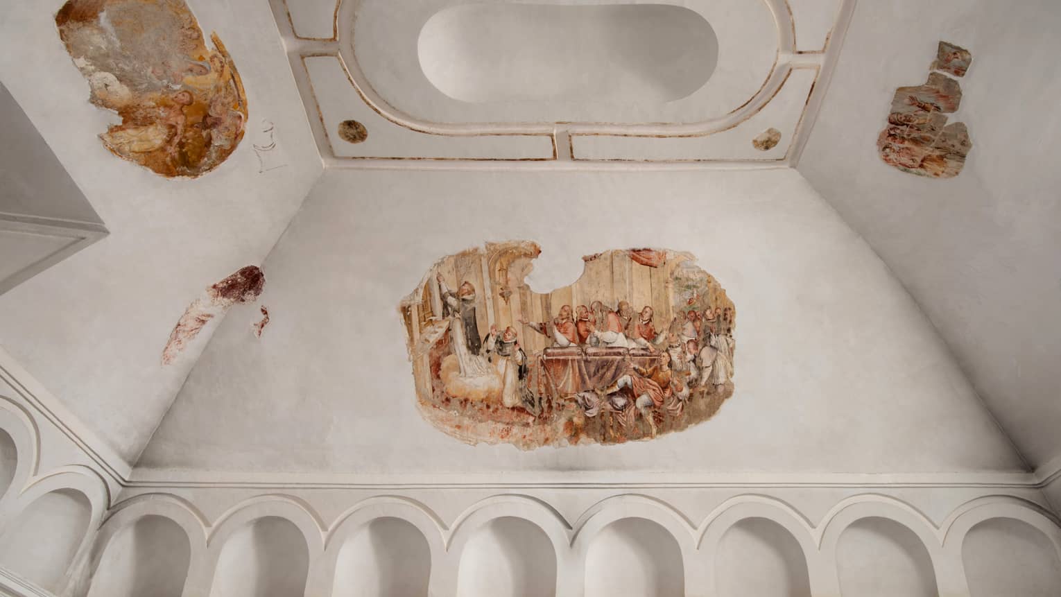 Frescos on white vaulted ceiling