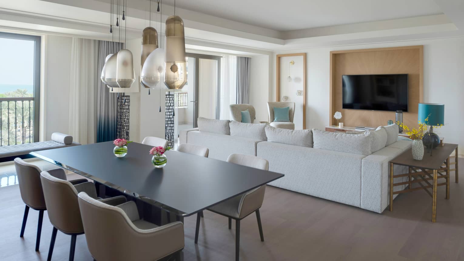 Black dining table with six chairs, abstract hanging light, living room