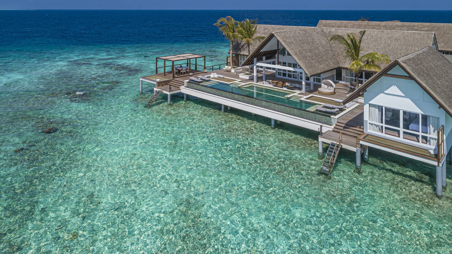An above-water retreat with a private pool overlooking the crystalline waters of the ocean