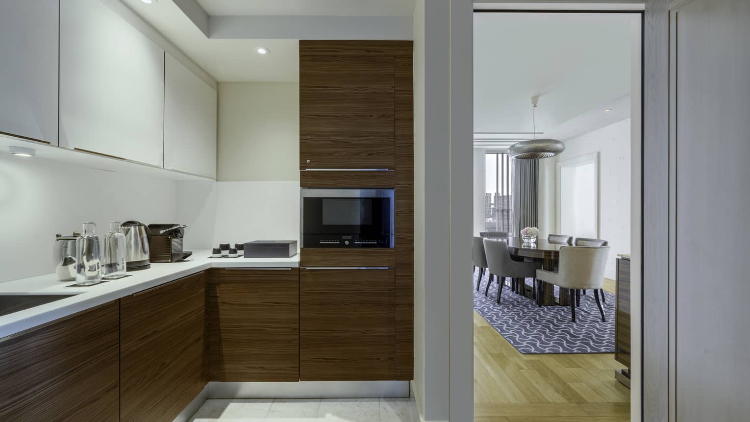 Modern kitchen with wood and white cupboards in luxury hotel suite