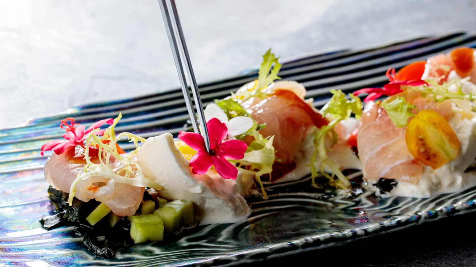 Red Mullet with little flowers and chopsticks in it.