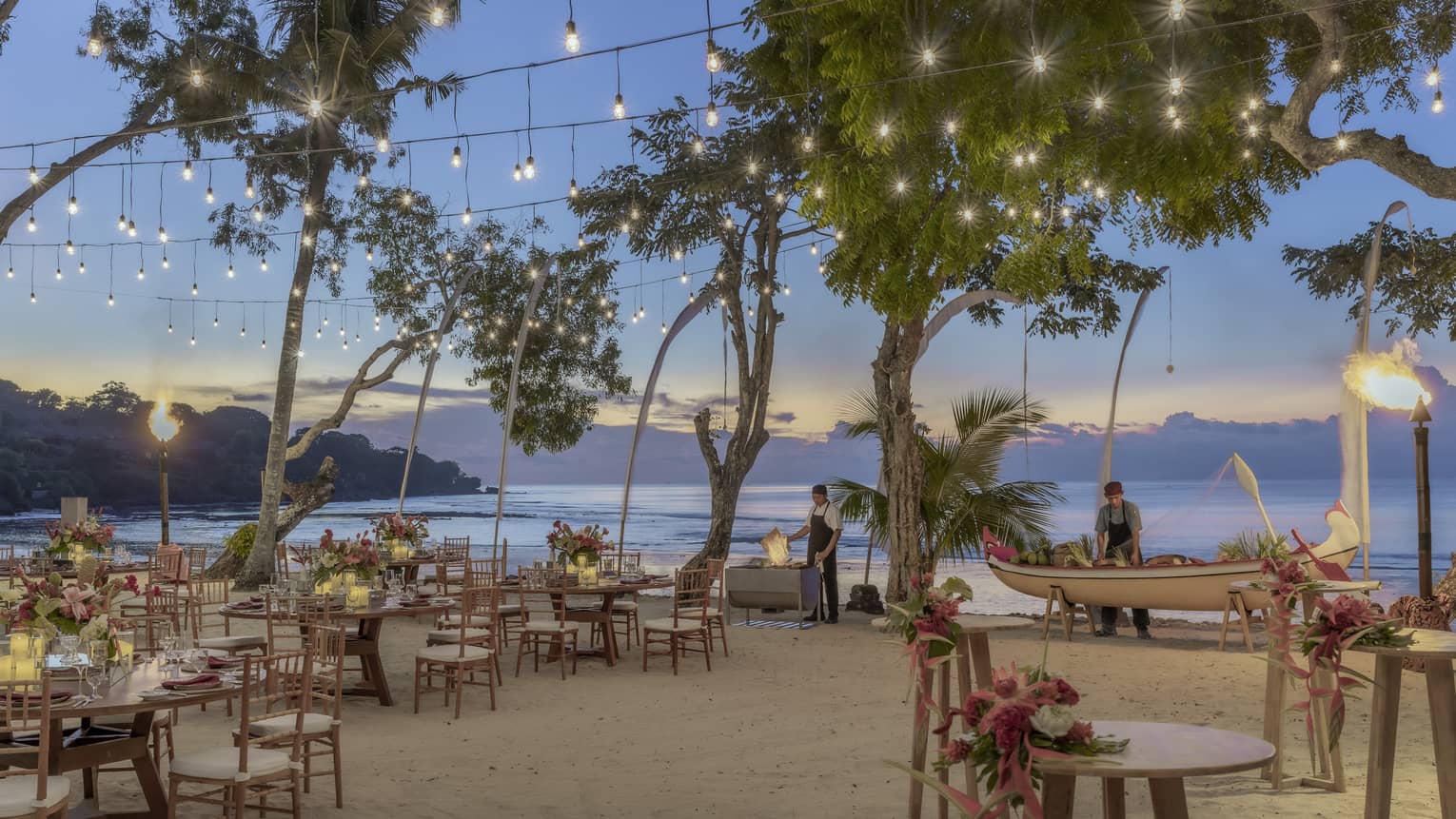 Beachside dinner setup with string lights