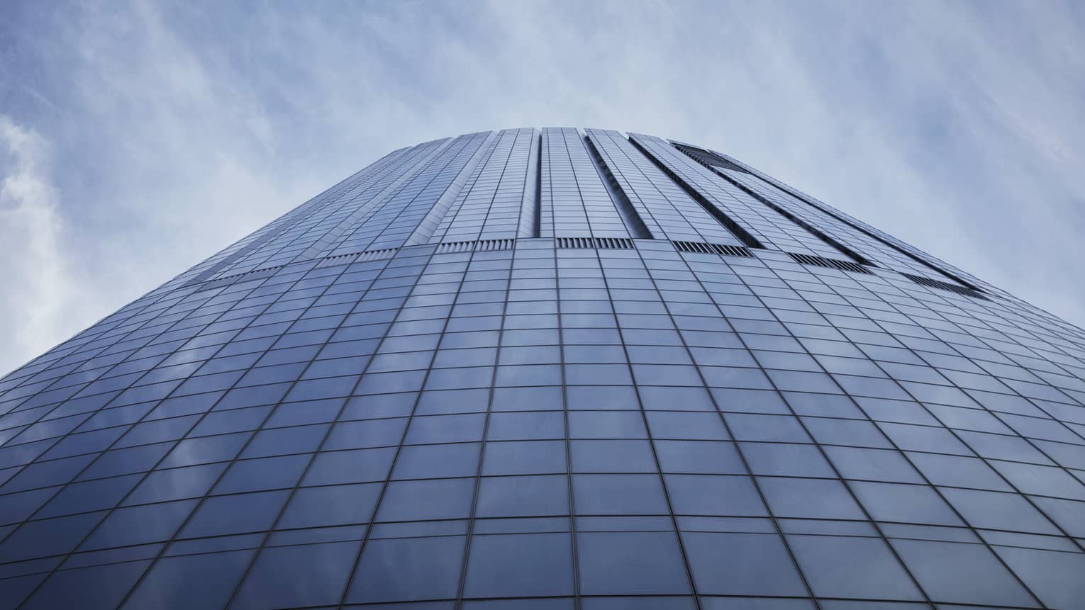 Exterior view looking from the ground up toward the top of a skyscraper