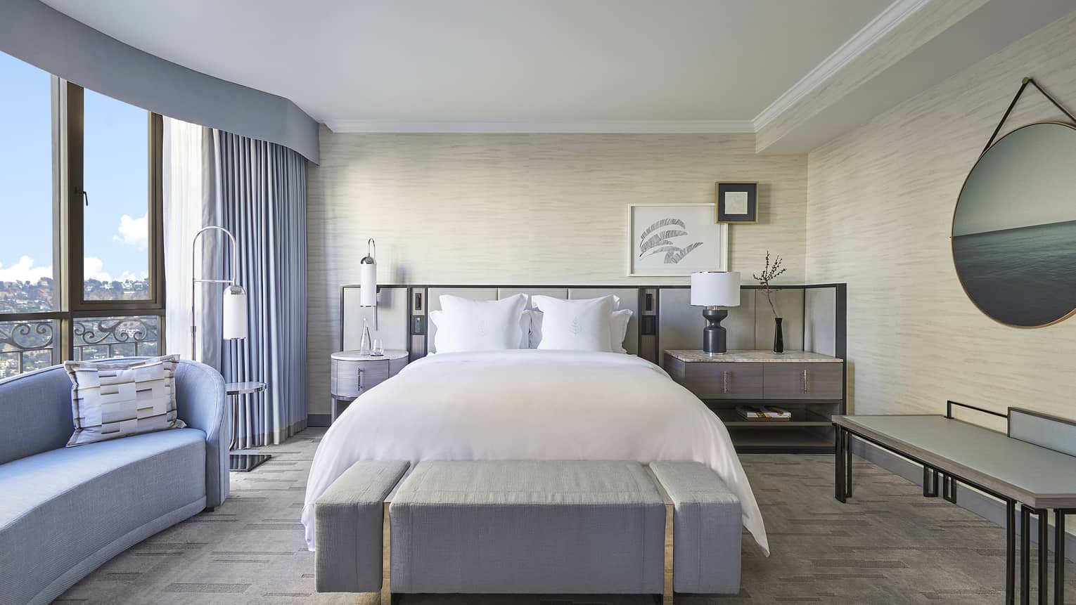Bedroom with king bed, cushioned bench and chaise
