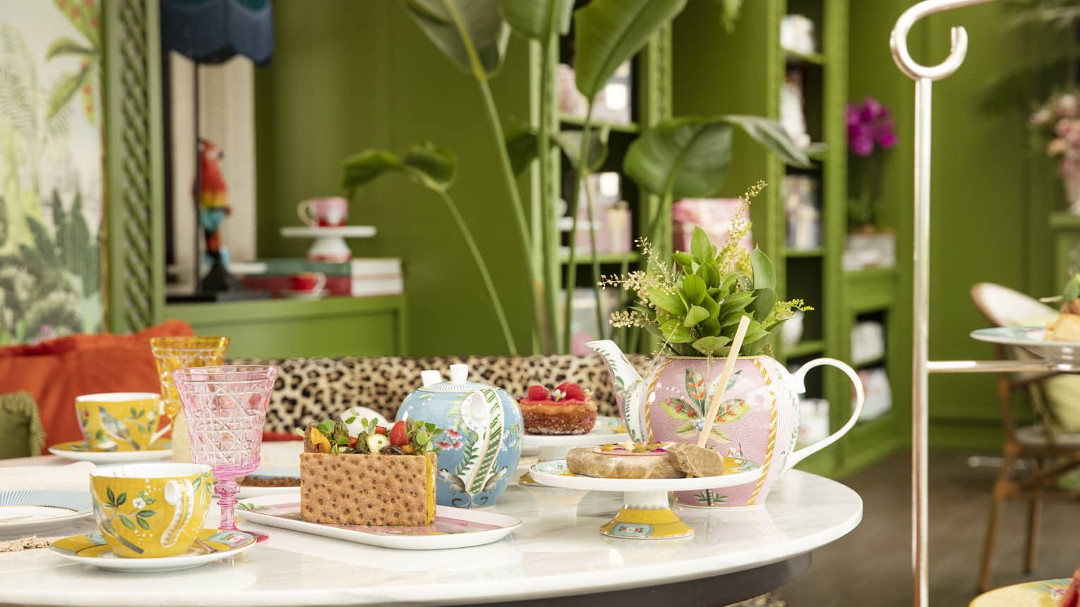 Round table with colourful tea cups and sweets at YASEMIN