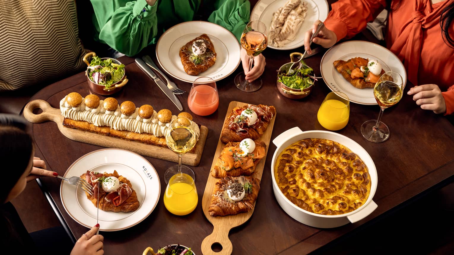 People seated, sharing a buffet of brunch dishes
