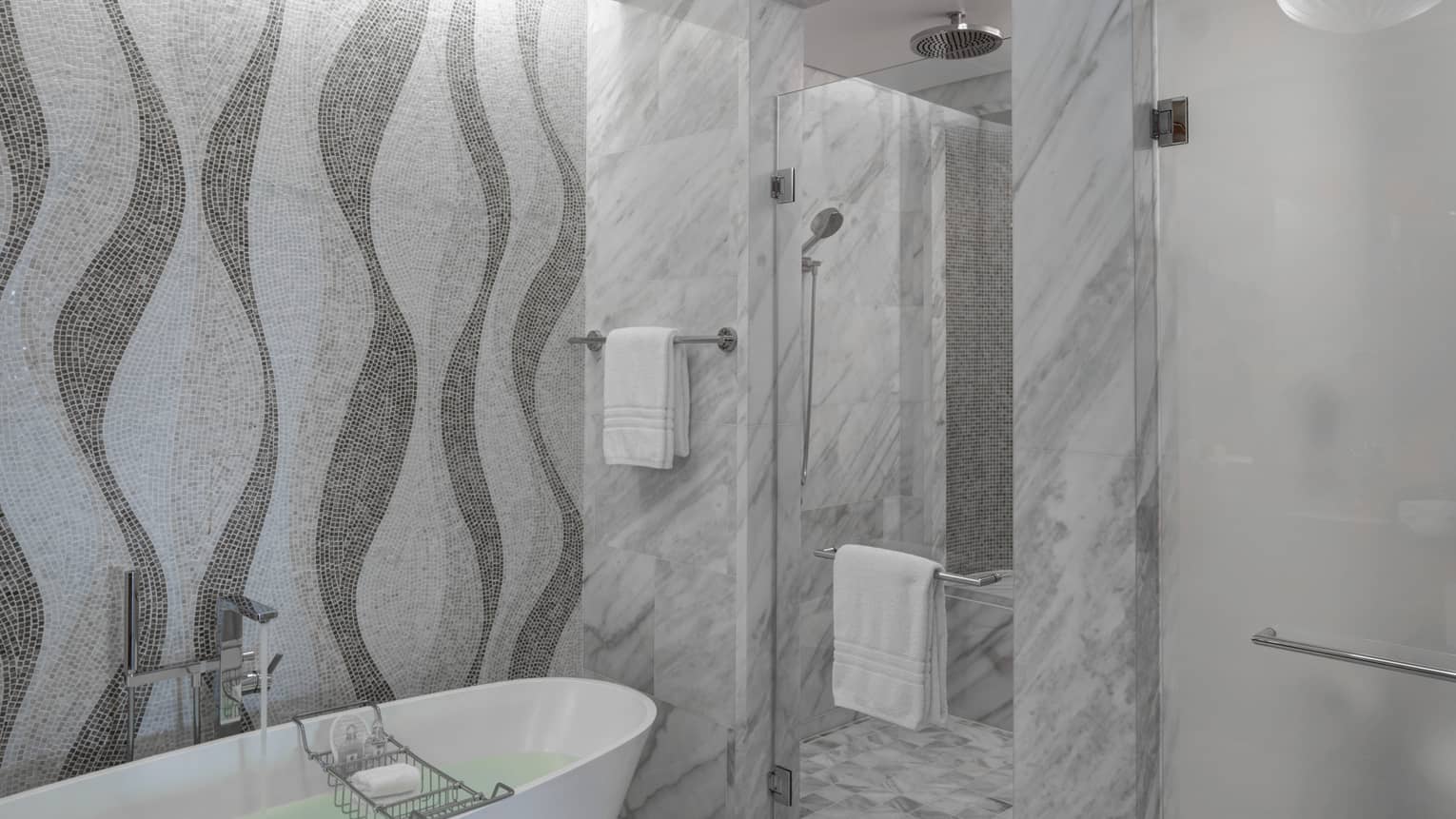Bathroom with marble shower, mosaic tiled wall, freestanding tub