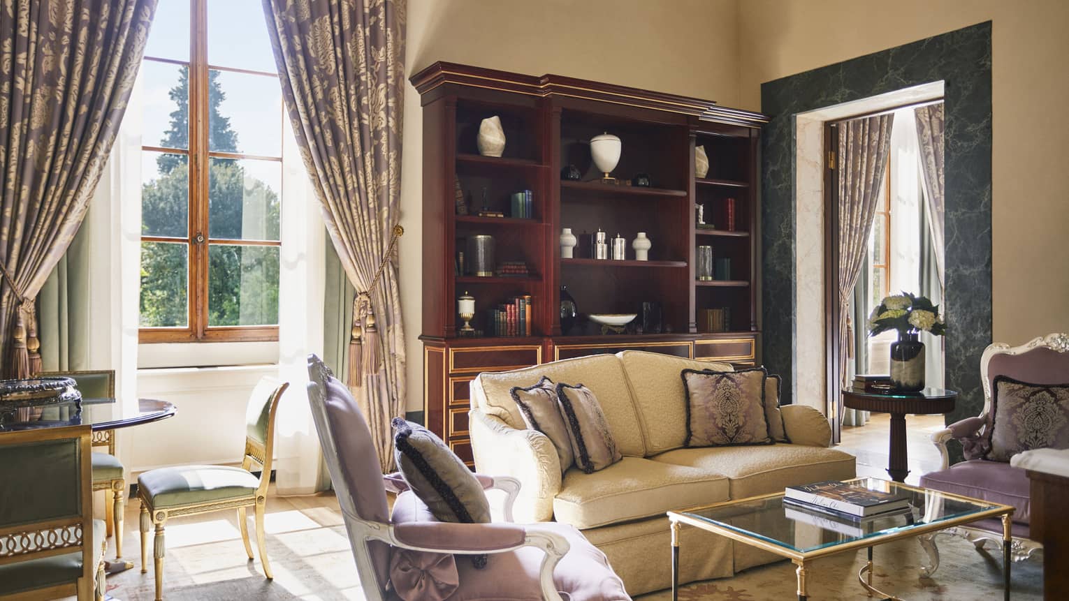 Frescoed Executive Suite living room with sofa, two arm chairs, and table with chairs, at Four Seasons Hotel Florence