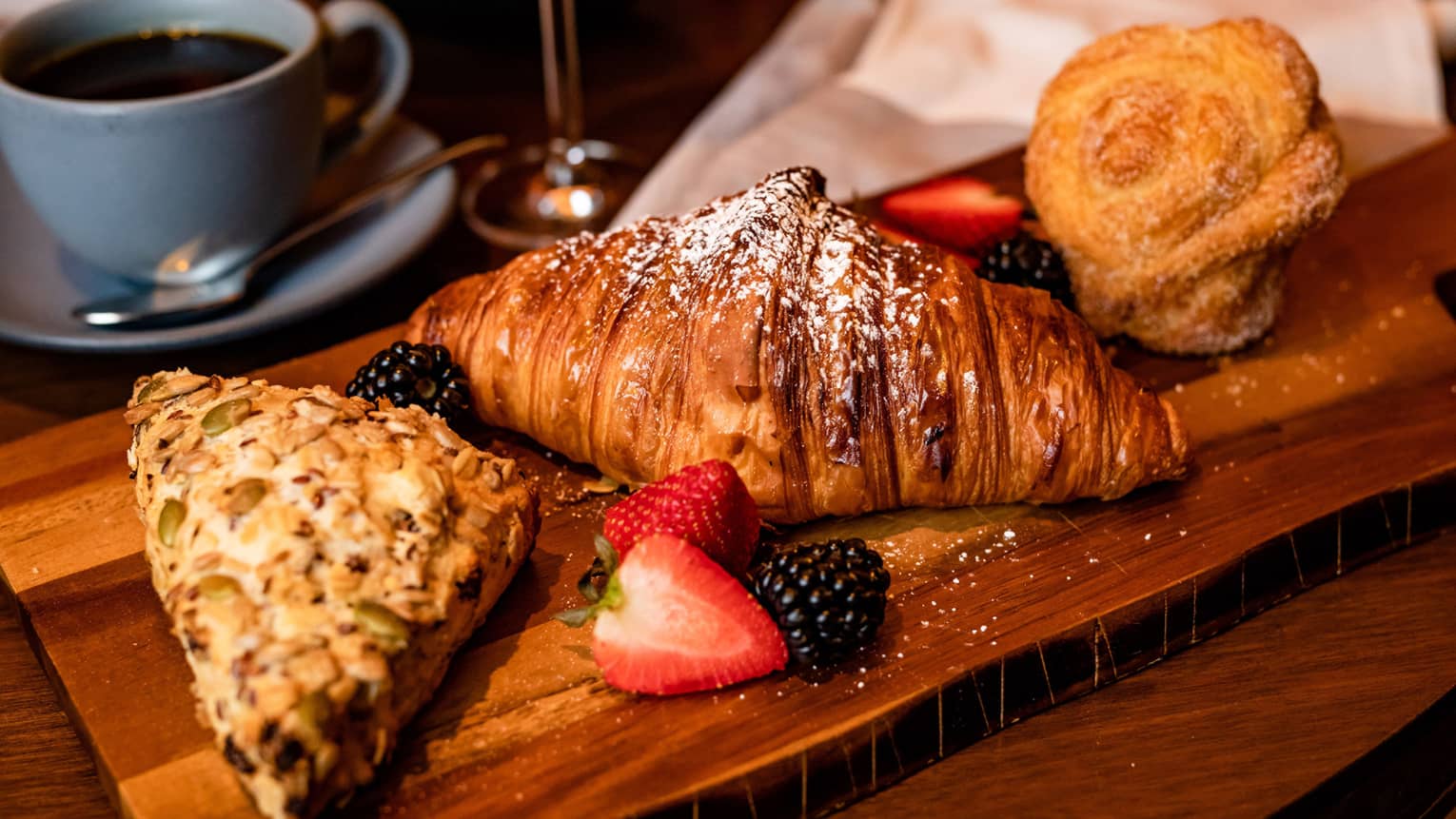 An assortment of pastries including scones and croissants.