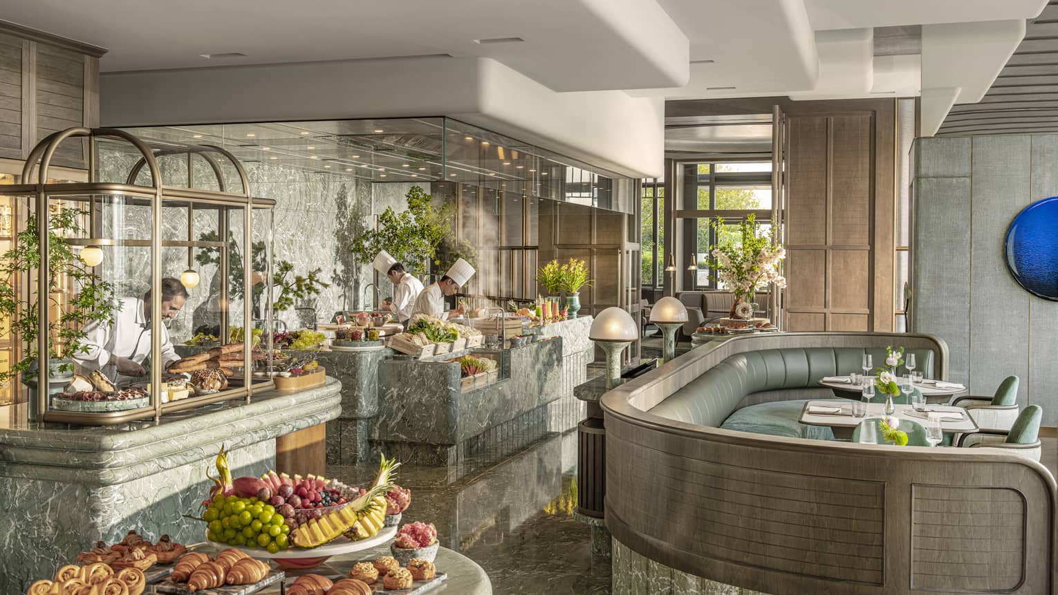 Chefs work at live-cooking stations at all-day restaurant Charm at Four Seasons Hotel Hangzhou at Hangzhou Centre