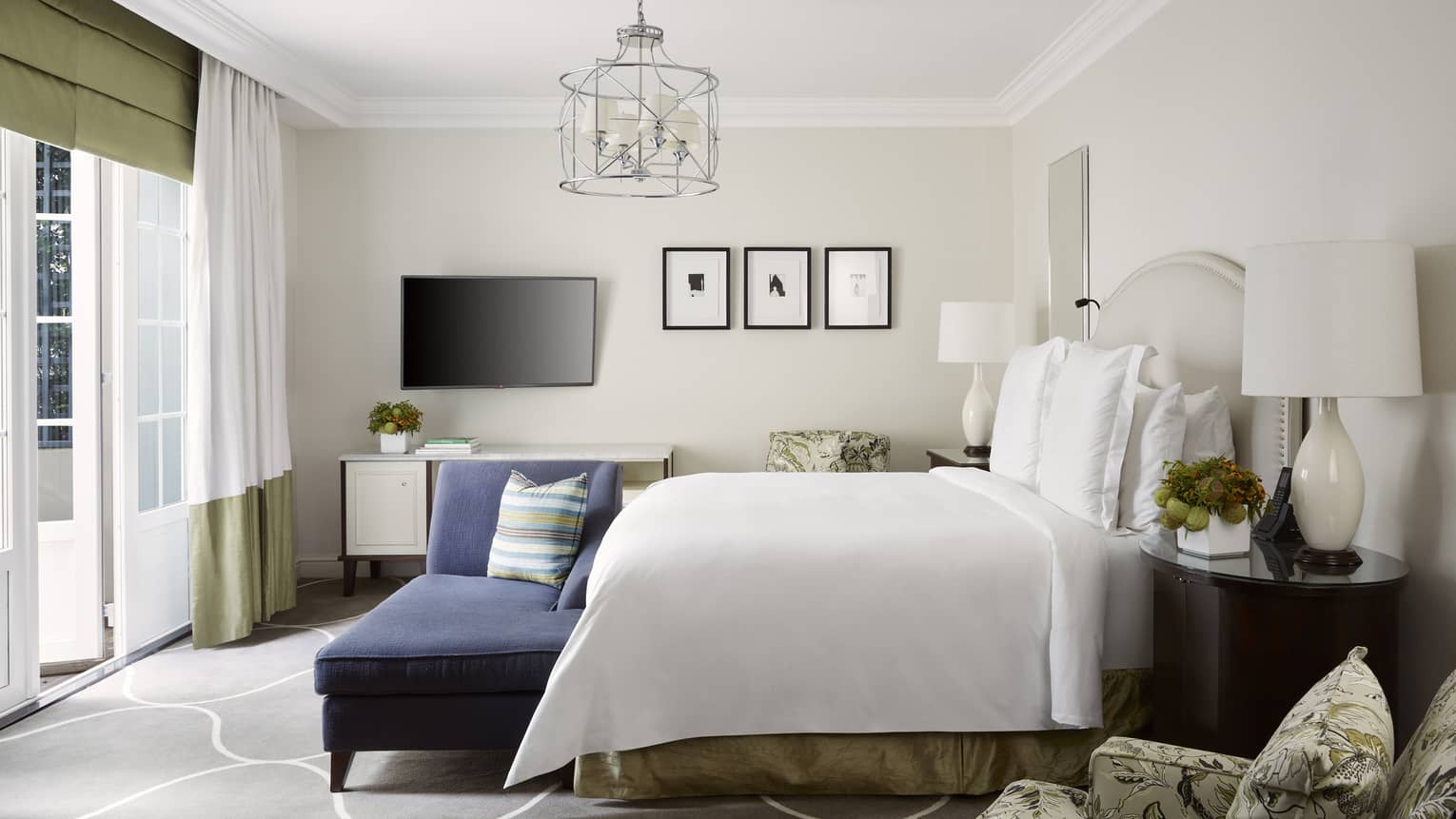 Garden-View Deluxe Room with king bed, dark blue chaise, and walk-out terrace at Four Seasons Hotel Johannesburg