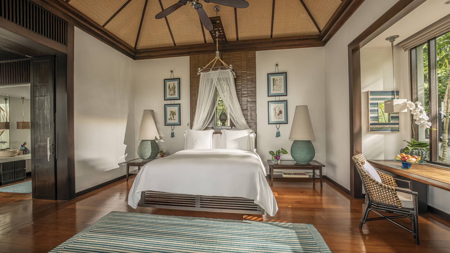 Master bedroom with teak floors, king bed with canopy net, vaulted ceiling and ceiling fan