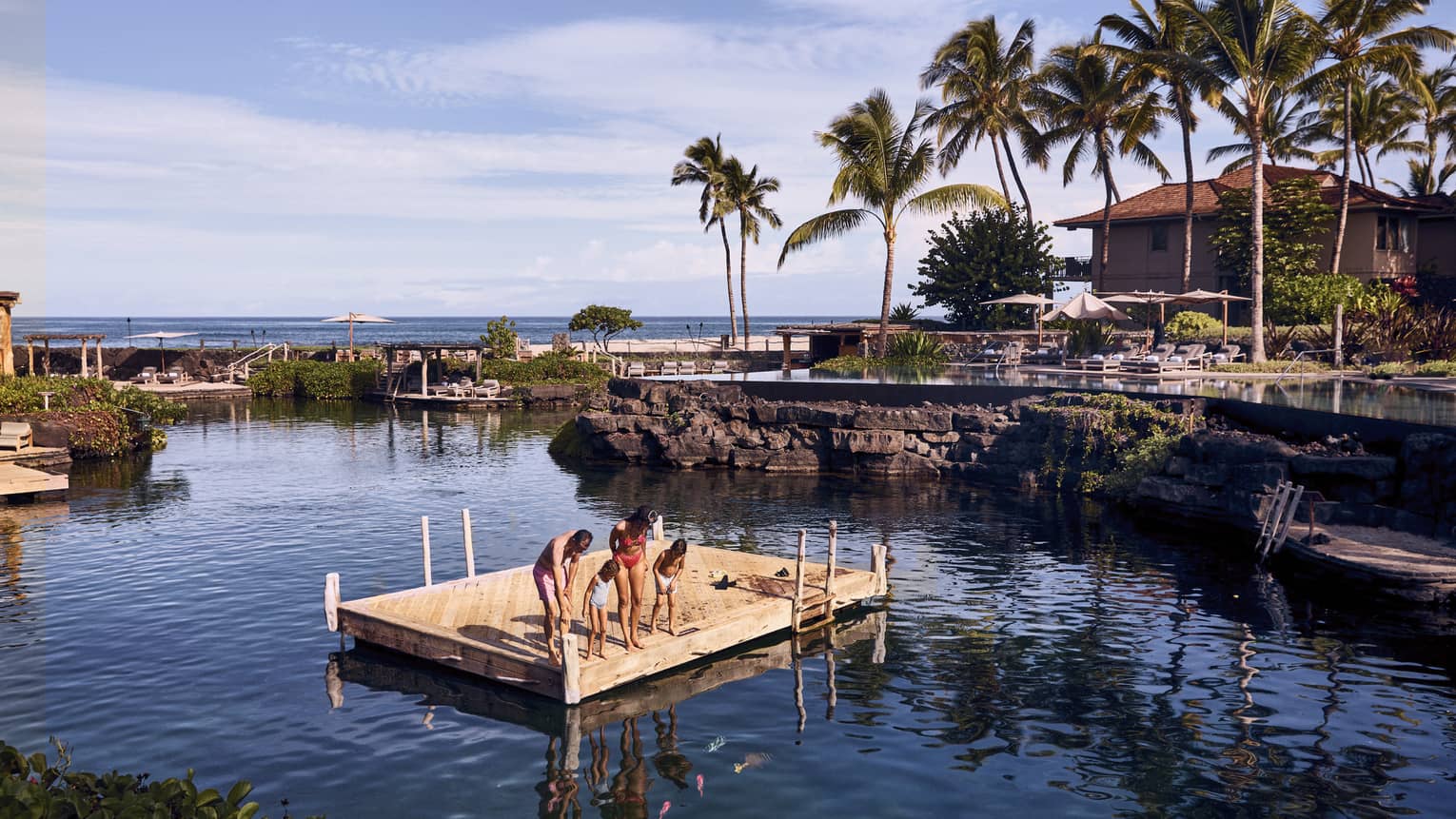 Small floating platform in the middle of a pond-like pool at a tropical resort