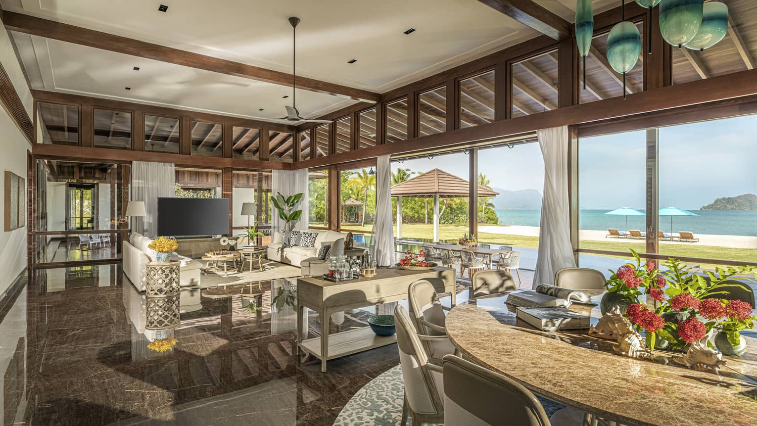 Large dining room and living room, opening up to a private pool terrace and beach view