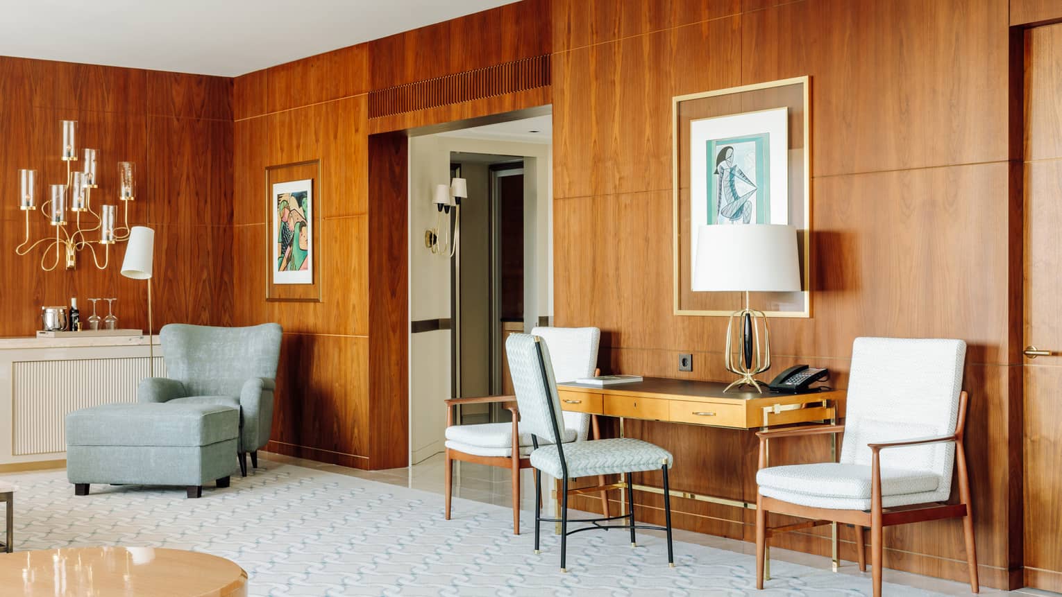 Living room with desk, wood-panelled walls