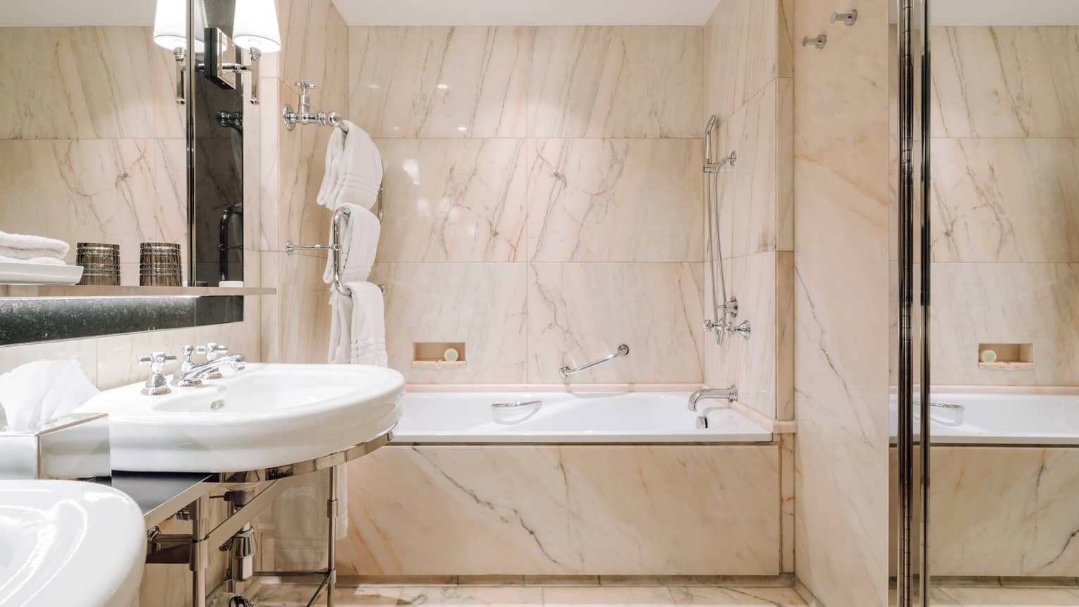 Marble bathroom with built-in tub and shower combination