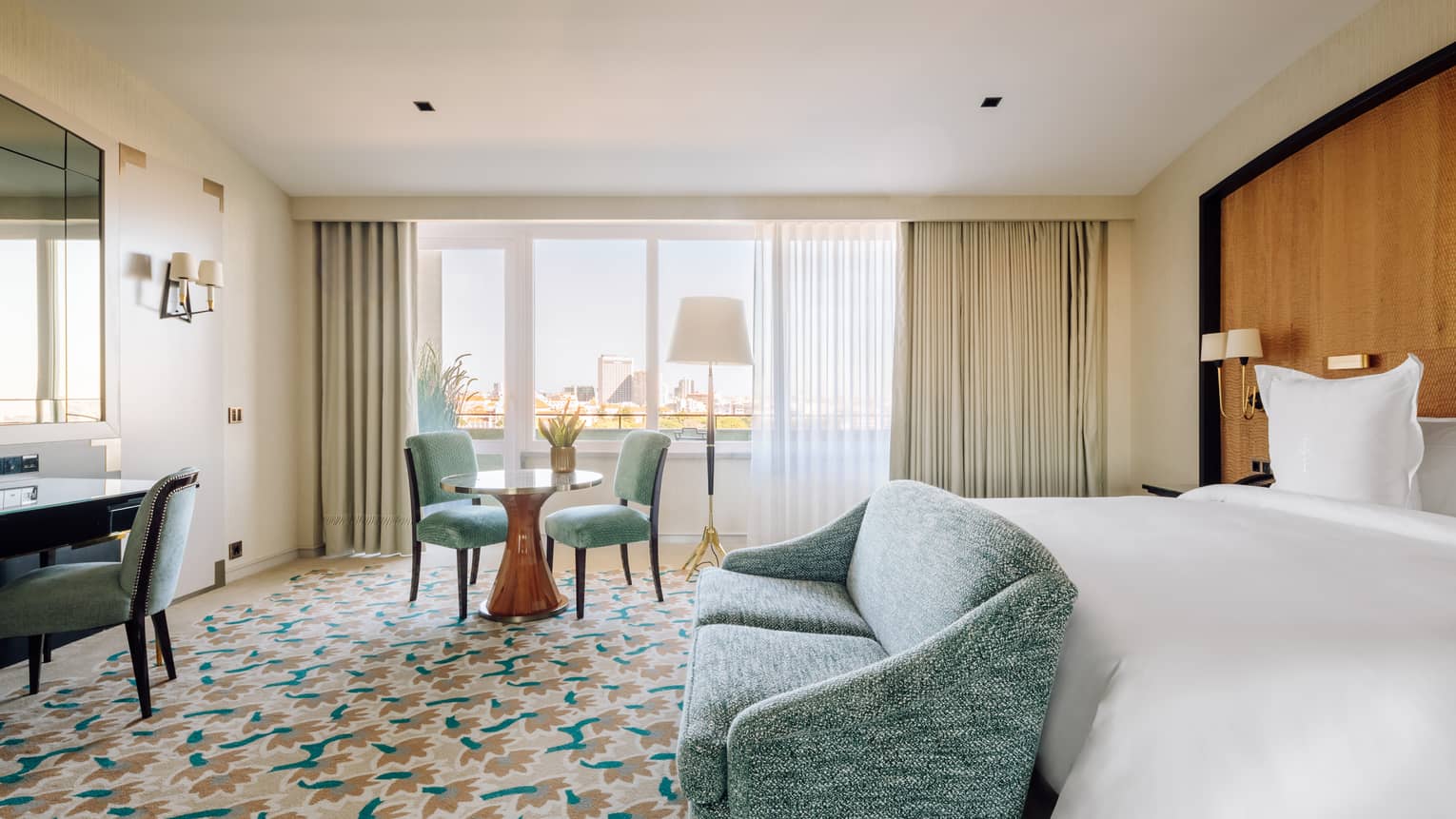 Bedroom with turquoise love seat and chairs