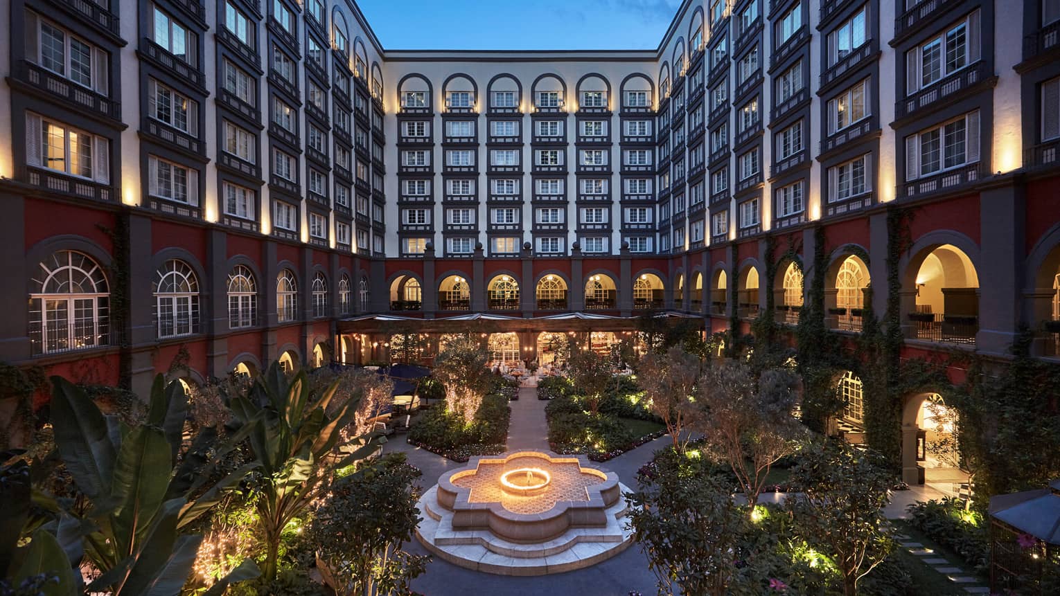 Inner courtyard garden below Four Seasons Hotel Mexico City with lights at night