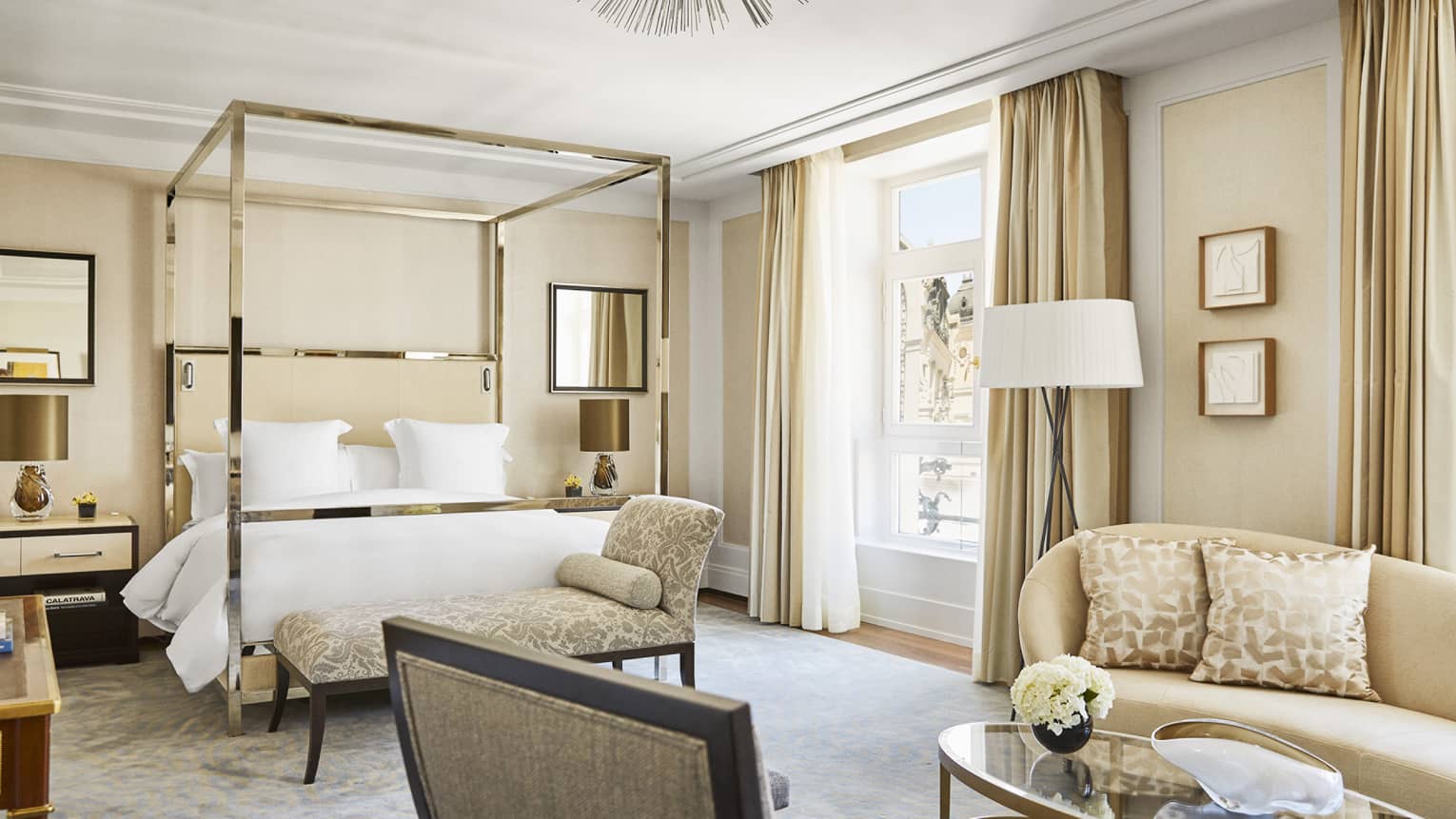 Luxury hotel bedroom with a modern four-poster bed, beige sofa, glass coffee table and large window with city views, decorated in neutral tones