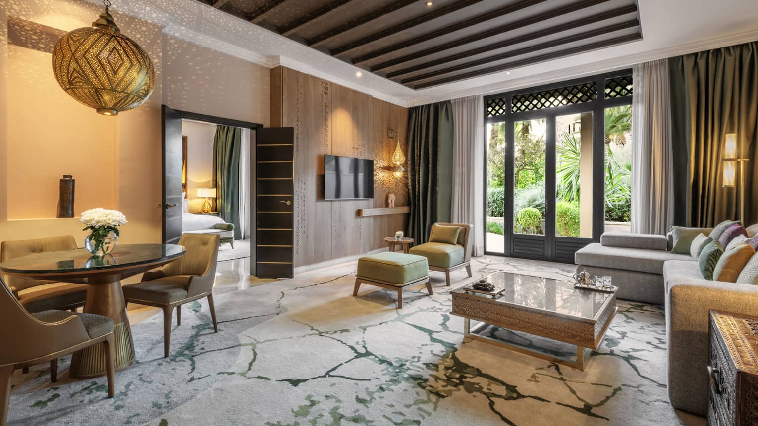 Living room with illuminated Moroccan lighting fixtures and garden view