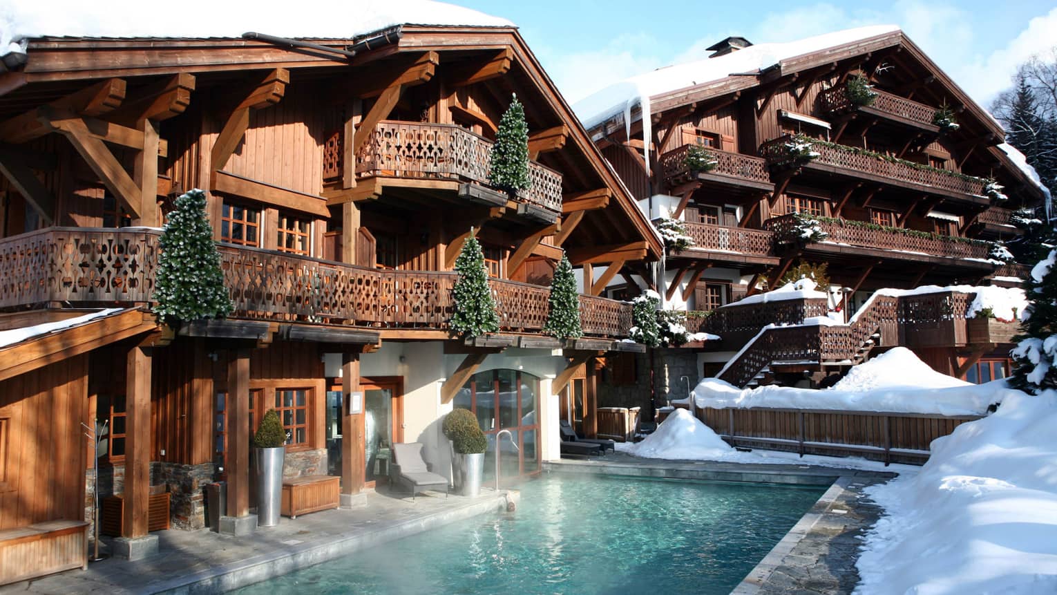 Spa lodge with heated outdoor swimming pool, snow-covered deck