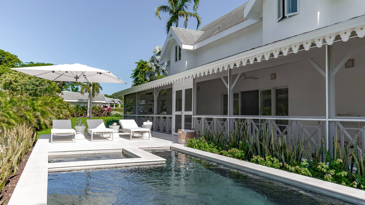 Home with pool and three sun loungers in tropical location