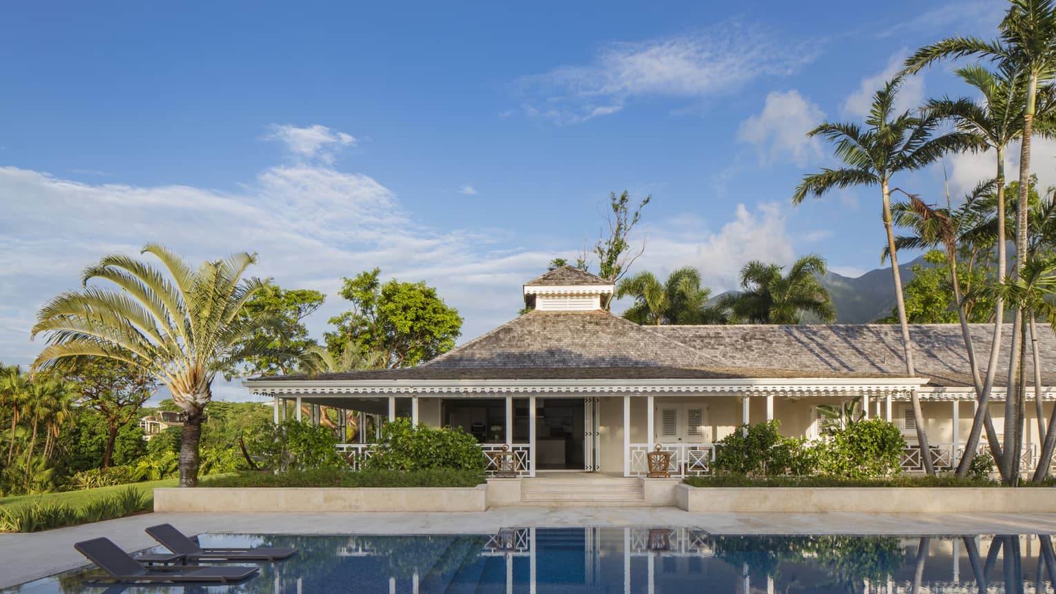 Large, private plunge swimming pool, floating lounge chairs outside Palm Grove Residence Villa