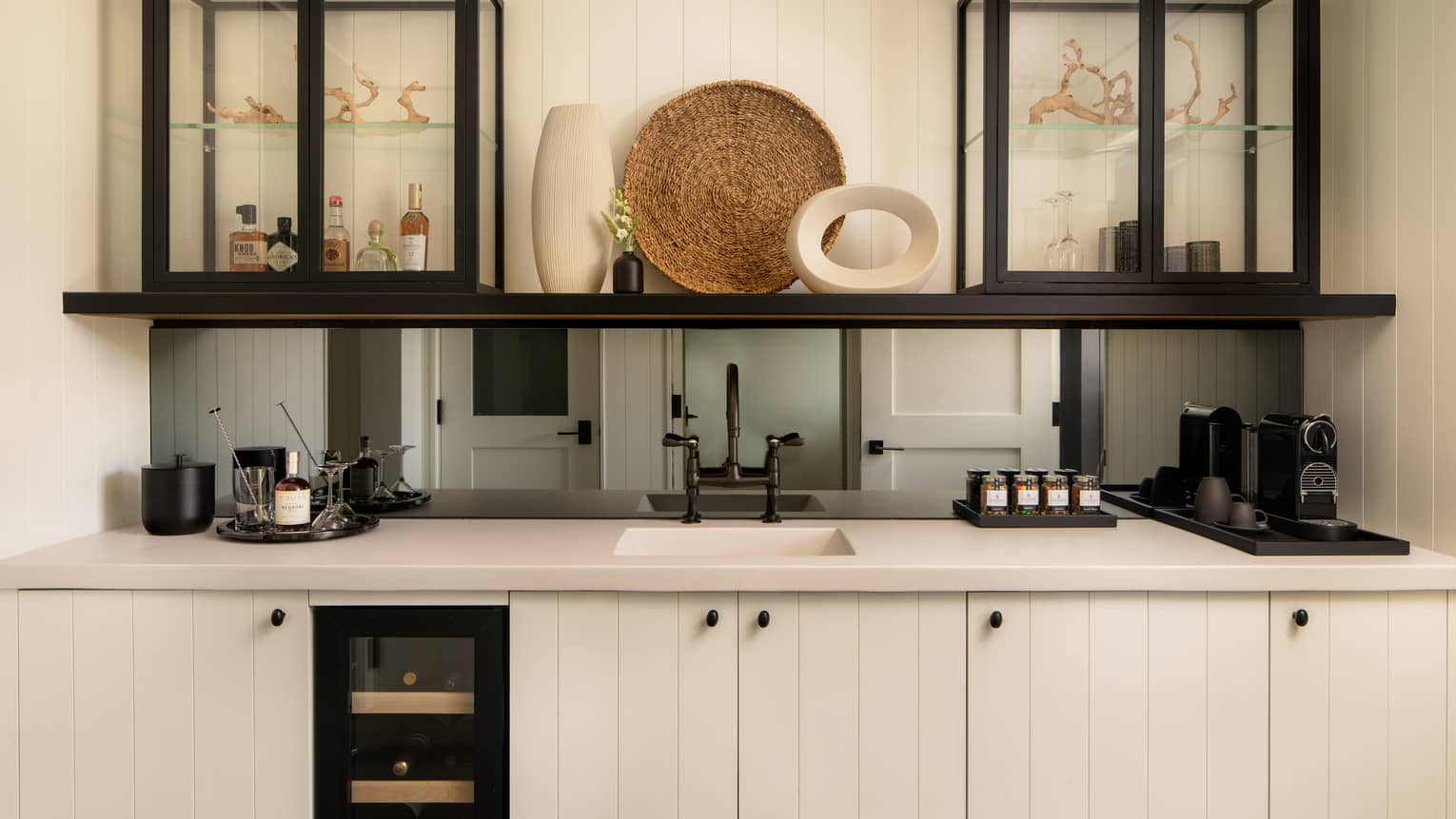 Wet bar, featuring a small wine fridge, sink and coffee station