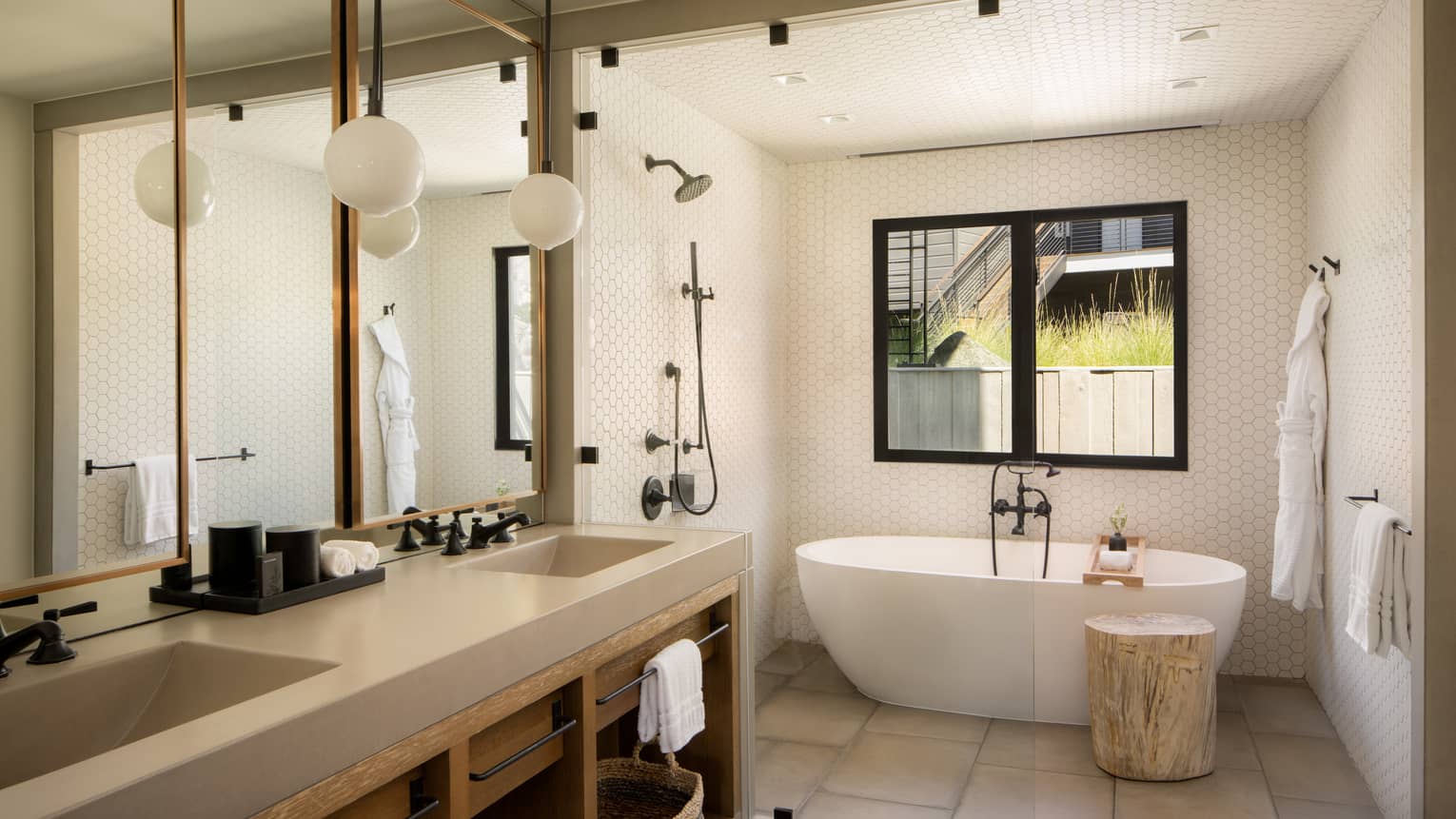 Contemporary bathroom featuring double vanity, and shower room next to a standalone tub
