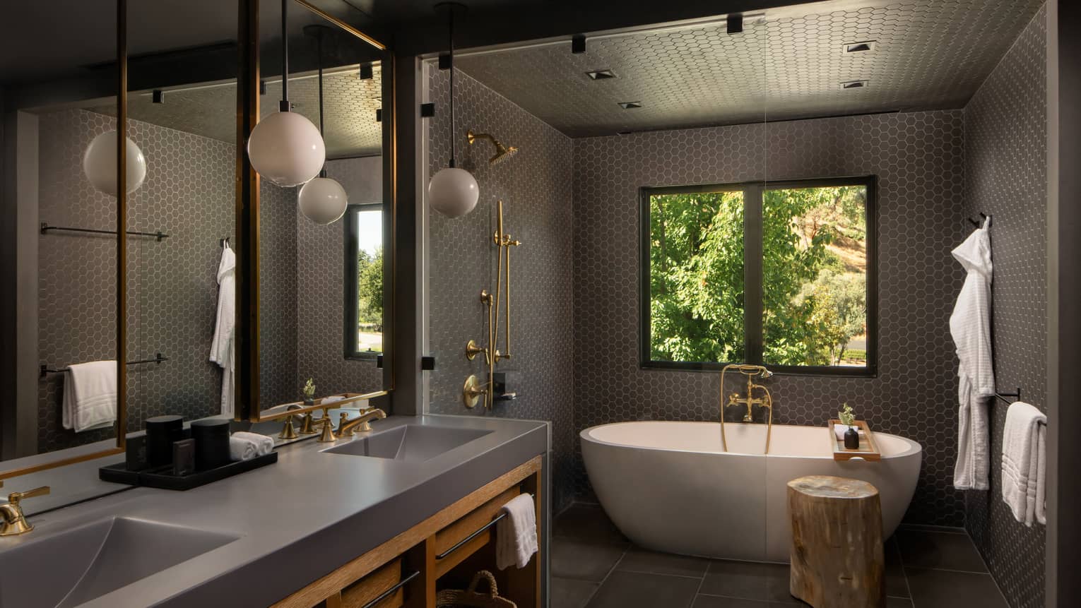 Contemporary bathroom featuring double vanity, standalone tub and dark grey walls