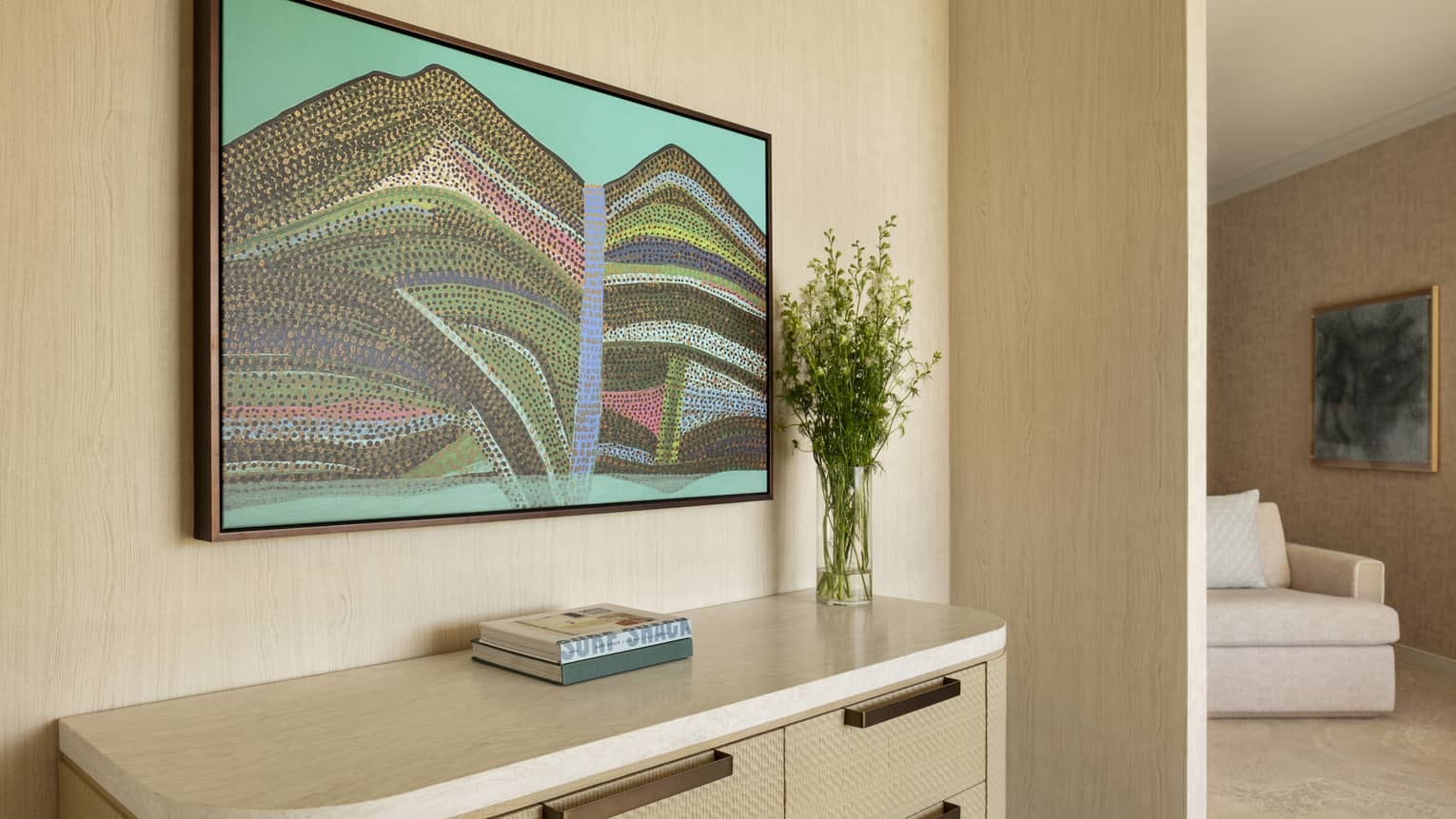 Contemporary resort suite hallway featuring an abstract Hawaiian painting above a dresser